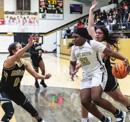 HUGO LADY BUFF KAYDRIN SCOTT moves the basketball through the Broken Bow defense to make something happen for her team during recent action at Simon Parker Gymnasium in Hugo.