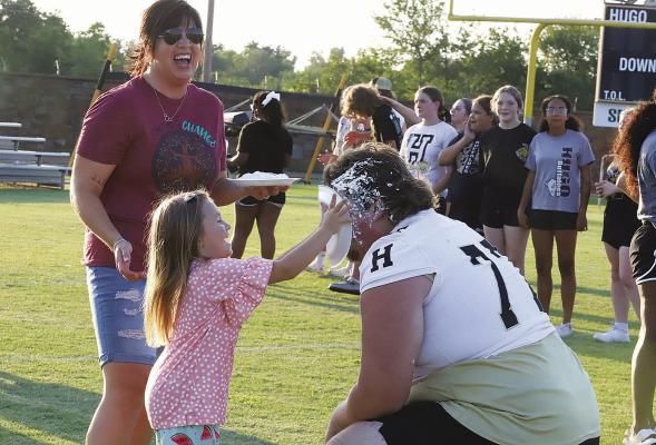 Hugo Buffalo Connor Frazier took a pie to the face from little sister Lily last week, as mom Michele looks on. The Buffaloes hold this pie auction each year to kick off the new season of football. See today’s Sports for more, page 1B.