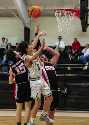 ALLEN HUTCHINSON battles Soper’s Kody Ainsworth and Jay Schott for a rebound during last week’s battle at Fort Towson. Hugo News Photo / Bobby Hamill