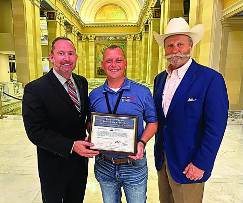 Chocta w County Ambulance Authority director Randy Springfield (center) is pictured receiving the certificate.