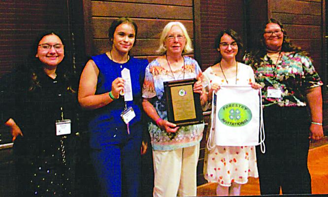 Above: 4-H National Forestry Judging Contest Tommy and Susan Futral Inspiration of the Invitational Award fourth place team: Stacey Scott, 14th overall individual; McKayla Brents, third overall individual, third pulpwood toss, fourth crosscut sawing; Alicia Brents, 4-H Forestry coach; Samantha Scott, eighth overall individual; Autumn Diggs, fourth crosscut sawing. 