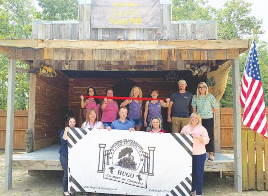 Left: Members of the Hugo Area Chamber of Commerce Board of Directors celebrate the Sawmill Family Pub’s opening alongside owners Melissa and Troy Hickman and their employees on Aug. 5. Photo Courtesy / Hugo Area Chamber of Commerce