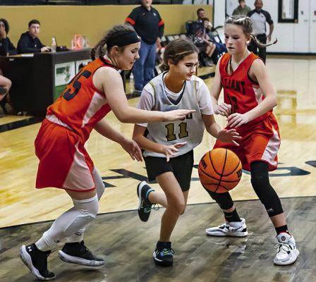 (LEFT) JAYLA TEAGUE dribbles through a double-team in recent tournament action against the Valliant Lady Dawgs. Hugo News Photo / Bobby Hamill