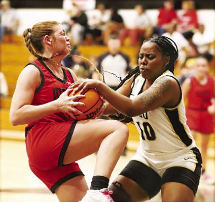 KELICIA SHELTON turns up the defensive heat on an Antlers player during the Regional Tournament in Idabel. The Bearcats brought the wrong uniforms and had to borrow uniforms from host Idabel. Hugo News Photo / Kelli Stacy