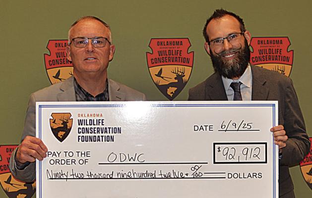 ODWC Director Wade Free poses with OWCF Executive Director Sean McCabe who presented a donation of $92,912 for a variety of projects, including youth shooting sports and equipment for game wardens.