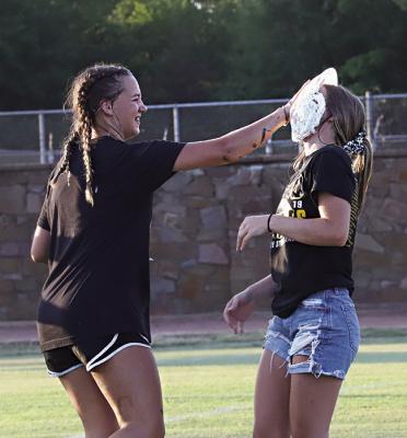 FRESHMAN BROOK WARD gets her chance to pie senior Jodi Emberson during the Hugo Buffaloes’ big fun fall fundraiser at Gene Nesbit Stadium last week. Hugo News Photo / Kelli Stacy