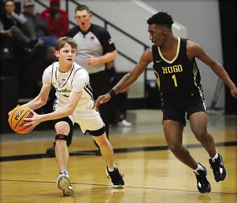 JAMARION BROWN puts defensive pressure on a Lone Grove guard during the Regional basketball tournament last week in Lone Grove. The Buffaloes defeated Lone Grove but fell to Purcell in a close game Saturday. Hugo will face Okmulgee Thursday in Ada. Hugo News Photo / Kelli Stacy