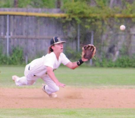HUGO SECOND BASEMAN Kolby Worthy makes a great diving defensive play Monday in a District clash against the Antlers Bearcats. (Hugo News Photo / Stan Stamper)