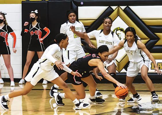 HUSTLING DEFENSE! — The Hugo Buffaloes battled to an overtime win against Morris to advance to the Regional Finals last week, where they defeated the Lady Cougars of Keys. Above, Asia Jordan, Kaydrin Scott, Jordan Holman and Don’Nai Akins surround a Morris player and force a turnover that was critical in the Lady Buffaloes’ 48-46 overtime win. (Hugo News Photo / Bob Hamill)