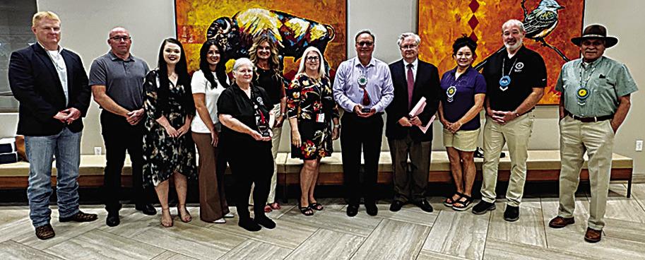 Representatives from OBI and Choctaw Nation blood drive champions pause with Chief Batton for a photo with the two awards.