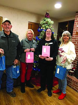 The Iris Garden Club bought gifts for residents at Elmbrook Nursing Home. Delivering the gifts to Donna Trapp (second from right) are (l to r) Rick Lowrance, Harolynn Wofford and Holley Lowrance.