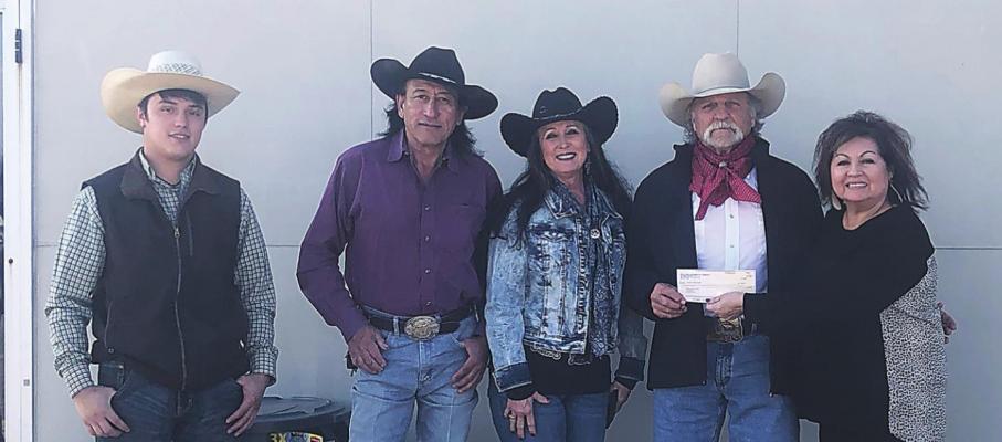 Gwen Coffman of FirstBank presents members of Cowboy Crossing Church