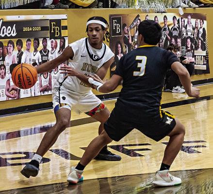KAYDYN JONES works the ball into the paint in recent Hugo Buffalo basketball action against Madill.