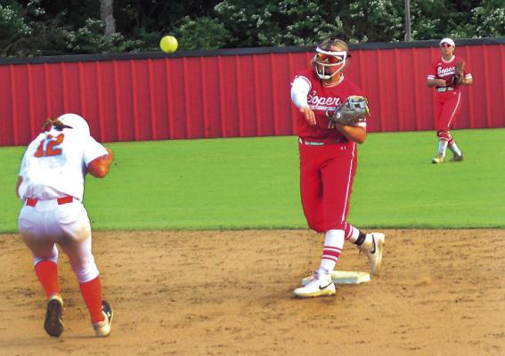 KABREY HARLESS takes the throw at second for the force out and fires a shot to first for the double play during regional softball tournament action last week. Brian Moore Photo