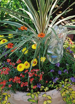 WATER OR WINE bottles can be combined with commercial products to help regulate the flow of water to container gardens while away on vacation. Photo Courtesy / MelindaMyers.com