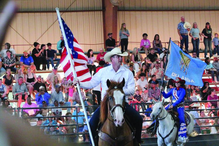 Oklahoma Governor Kevin Stitt presents the American Flag during the Grand Entry of the 62nd annual Hugo PRCA Rodeo Saturday evening.