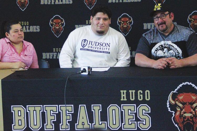 HUGO BUFFALO LUCIANO ROSALES signed a letter of commitment to play football at Judson University in Elgin, Ill. He is pictured with his father Armando Rosales and stepmom, Natalia Fusco. (Hugo News Photo / Krystle Taylor)