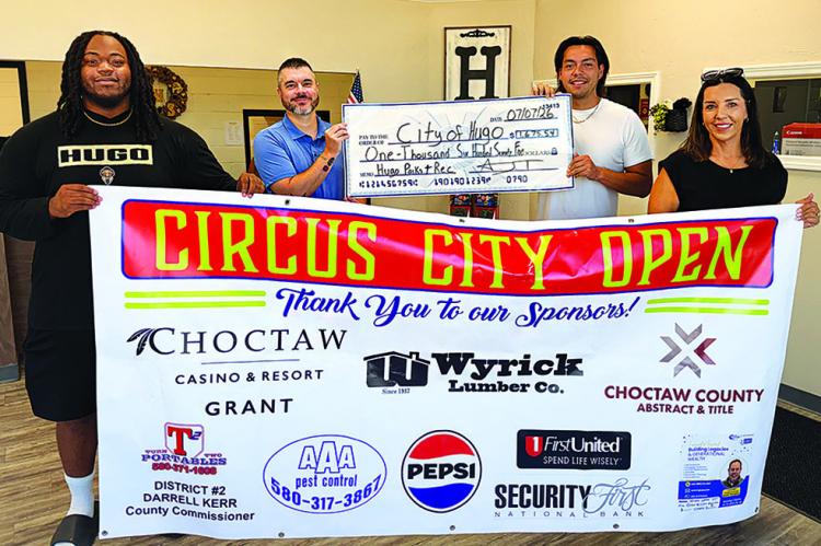 THE BIG PAYOFF! — Pickleball Tournament Director A.J. Thompson and volunteers Donte Shanklin and Bobbie Thompson were all smiles as they presented Hugo City Manager Justin Suddeth with the proceeds of the recent Circus City Open. The tournament was so successful plans for a fall tournament are already underway. Photo Contributed