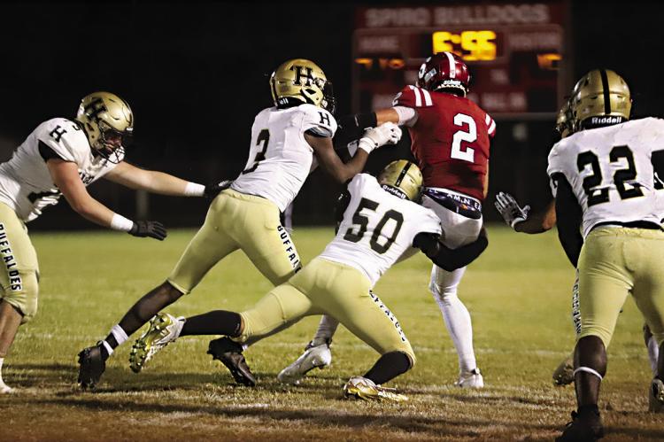 ISAIAH GREER breaks into the Spiro backfield to snare their running back for a loss, as teammates Malakhai Edwards, DaShon Sims and Ethan Sparks close in to assist. The Buffaloes had a total of 88 tackles for the night against Spiro Hugo News Photo / Kelli Stacy