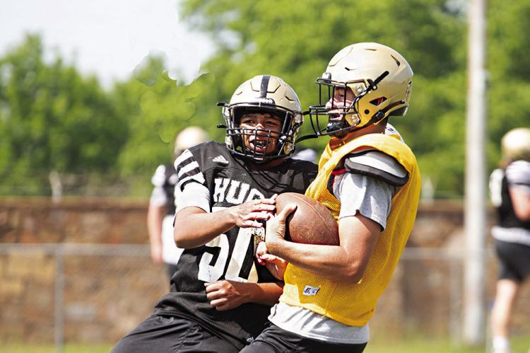 ISAIAH GREER makes contact with Hugo Buffalo Quarterback Jayka Santillan during spring training drills on Buff Parker Field in Hugo last week. The Buffaloes will be young but quick in their defensive program next fall. Hugo News Photo / Kelli Stacy