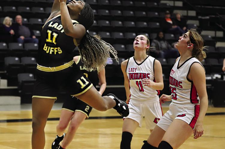 KE’SHAWNA SCROGGINS outraces two defenders to put up a shot against Comanche in a do-or-die game for the Hugo Lady Buffaloes. Hugo News Photo / Kelli Stacy