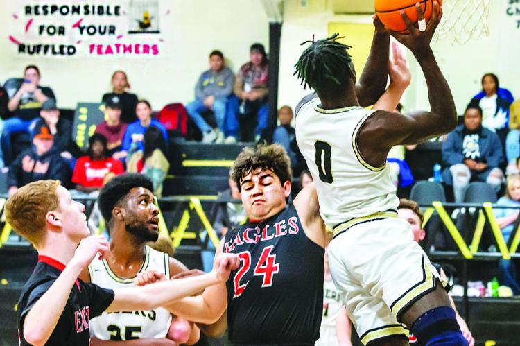 OMAR GARDNER breaks through the Victory Life defense and puts up two of his 12 points for the Fort Towson Tigers during last week’s home battle against the Eagles. Also battling defensively in the paint for the Tigers is teammate Deshon Rose.  Hugo News Photo / Bobby Hamill
