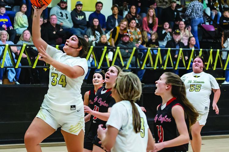 MADISON HUDSON outruns the Victory Life Lady Eagle defenders and puts up two points for the Fort Towson Lady Tigers during a recent home court battle. Racing down the court to assist are teammates Taylor McKnight and Hailey Wyatt. Hugo News Photo / Bobby Hamill