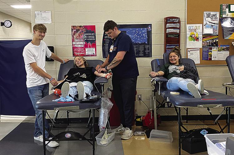 Hugo High School students donate at OBI Blood Drive hosted by the Leo Club on Sept. 7 at Hugo High. Pictured are: Chad Barnett, Jodi Emberson, OBI Tech, and Kendell Hicks.
