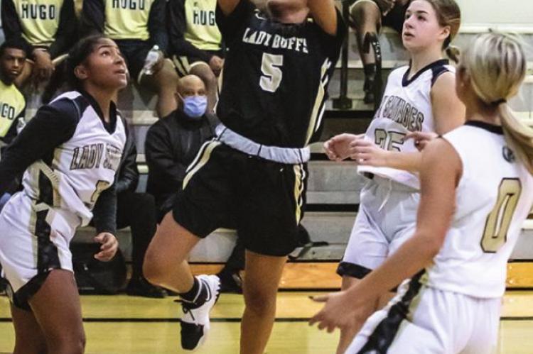 ASHIA JORDAN finds a seam in the Broken Bow defense and puts up two of her 10 points for the Lady Buffaloes in their win against the Lady Savages last week.