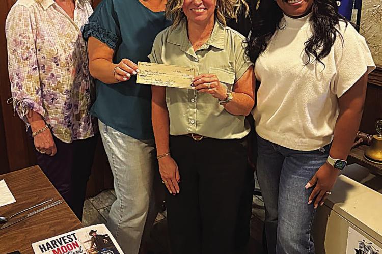 The Hugo Lions Club recently welcomed guest Amy White, who spoke about the Harvest Moon Festival to be held on Oct. 31 at Lions Park The Club donated $500 to help with the event. Pictured are Susan Brewer, President Royce Chandler, Dusty Williams, Amy White, Brandy Eller and Lindsey Adams