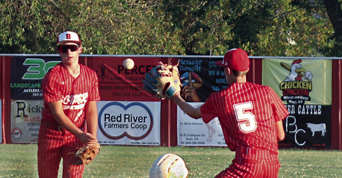 SOPER SHORTSTOP MASON MOORE scoops up a ground ball and throws to teammate Wylie Marsh at second base. Coach Springfield beamed after the come-from-behind Soper victory, bragging on his younger players who stepped up big for the win. Brian Moore Photo