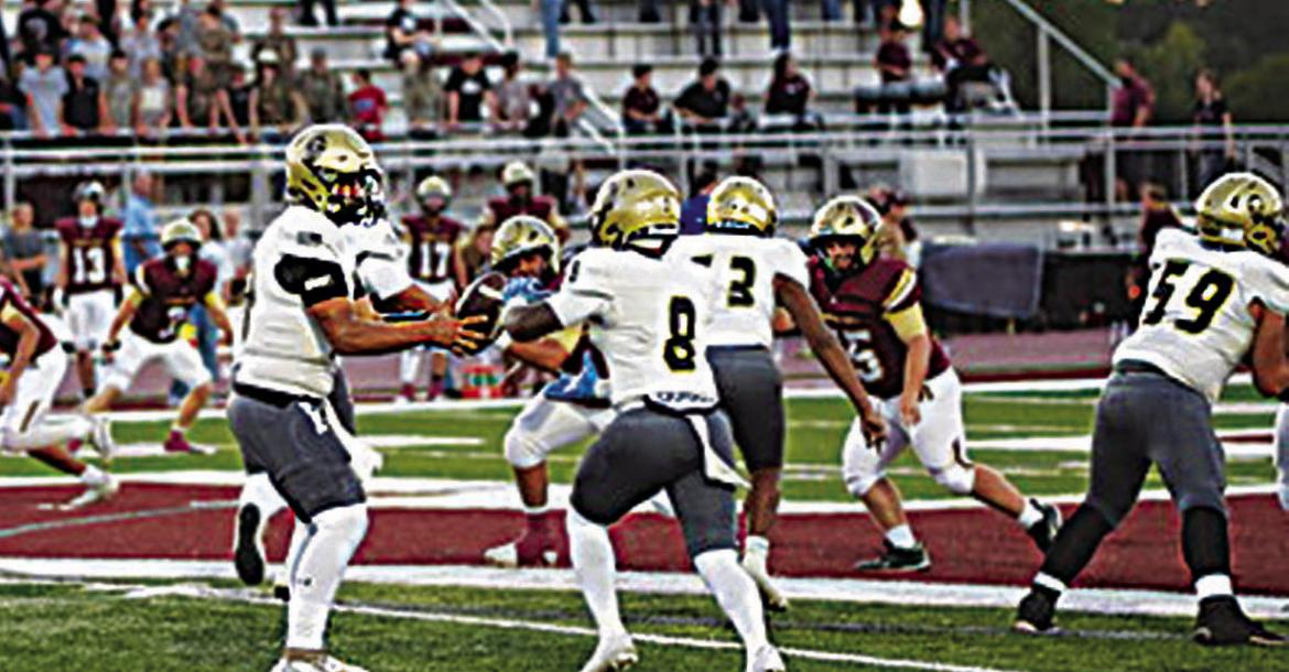 BUFFALO QUARTERBACK JAYKA SANTILLAN hands the football off to senior halfback Ja’Mari Scroggins behind O-Line blocking from Tamareon Jeffers and Draven Cook. The Wampus Cats are always tough on their home field, and the Buffaloes battled to a 27-22 victory. Photo by Ethan House Photography