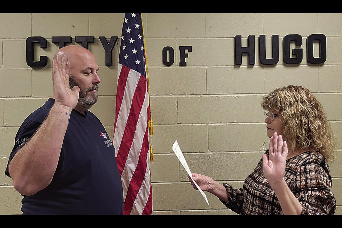 Running unopposed during the April 4 election was Ward 1 incumbent Josh Armes. He is pictured with city clerk Debra Searcy during the swearing-in ceremony held last Friday.