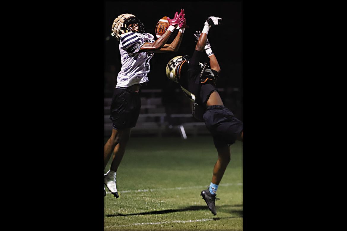QUINCY SHELTON, a sophomore for the Hugo Buffaloes reaches over a defender to make a big play during the Buffaloes’ midnight scrimmage last week. The Buffaloes will open their 2023 football season at home on Aug. 25 against Dickson with a 7:30 p.m. kickoff. Hugo News Photo / Kelli Stacy