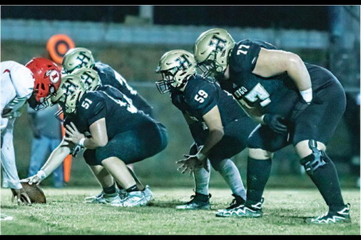 HUGO BUFFALO LINEMEN battling in the trenches for the offense this season include center Jayse Trantham (soph.), left guard Jonathan Chavez (soph.), and left tackle Connor Frazier (junior). The Buffaloes rushed the ball 31 times for 155 yards on the ground against the Warriors. Hugo News Photo / Bobby Hamill