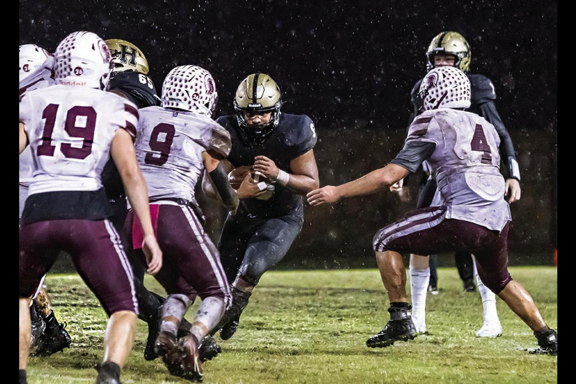 HUGO’s MOST PRODUCTIVE running back, Aden “Fuzz” Parish, was unable to break away from team tackles by the Ironheads on the rain-soaked turf of Buff Parker Field. Hugo News Photo / Bobby Hamill