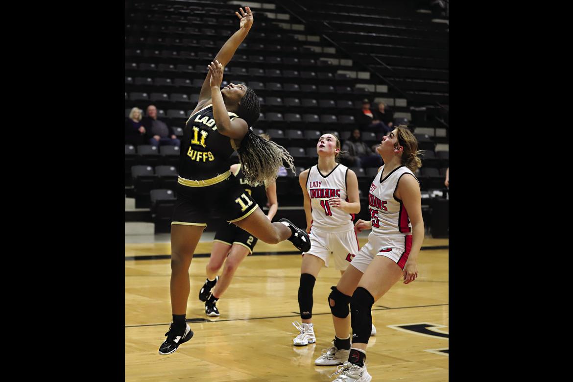 KE’SHAWNA SCROGGINS outraces two defenders to put up a shot against Comanche in a do-or-die game for the Hugo Lady Buffaloes. Hugo News Photo / Kelli Stacy