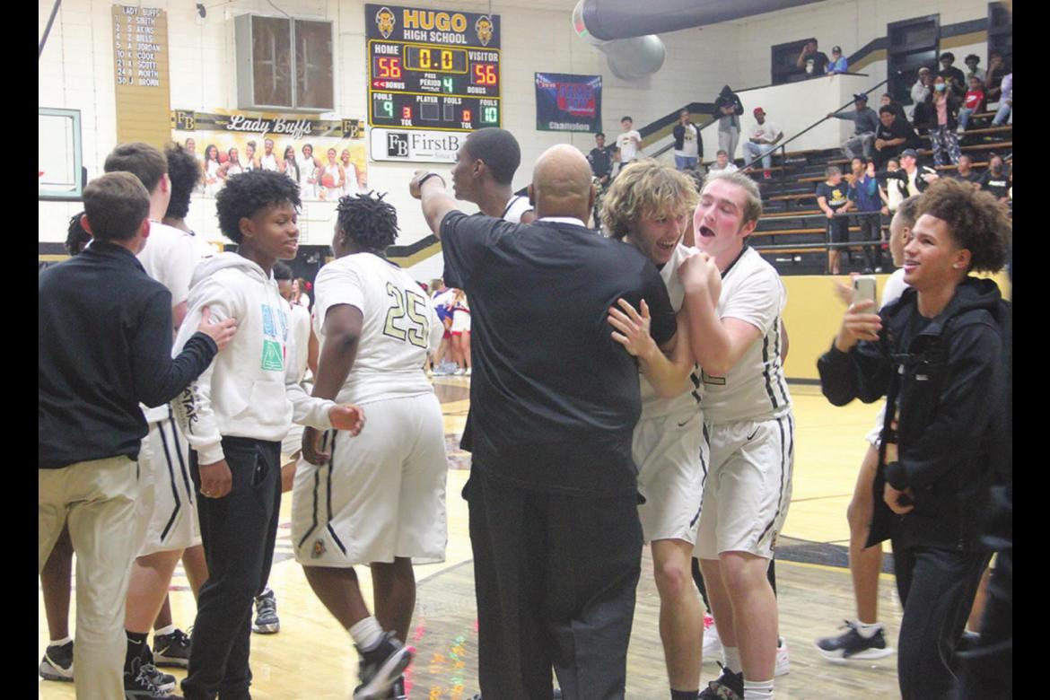 PIERSON EVANS celebrates with his teammates and hugs Coach Demontre Akins after Evans dropped the winning shot in front of the second overtime buzzer Hugo News Photos / Kelli Stacy