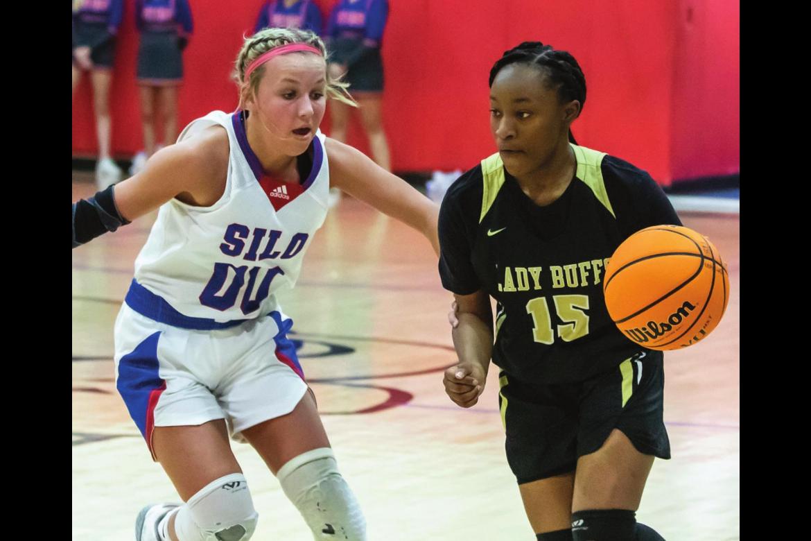 ZION BILLS drives the seams in the defense of the Silo Lady Rebels during recent basketball action at Silo. Bills hit a long-distance trey in the fourth quarter for the Lady Buffs, but it wasn’t enough to overcome the Lady Rebels, who took the game 34-41.
