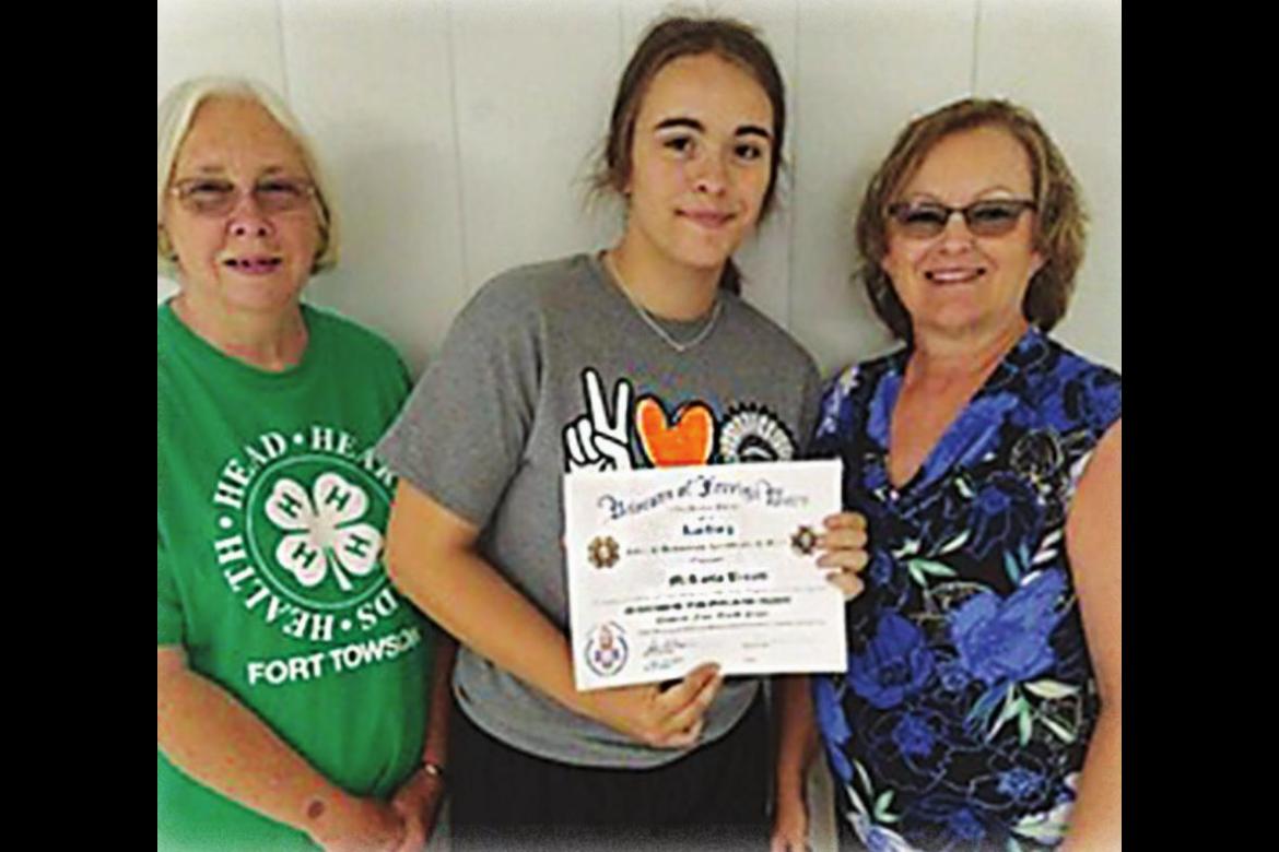 VFW VOICE OF DEMOCRACY ESSAY contest third place winner was Fort Towson resident McKayla Brents, representing Fort Towson High School. Presenting her certificate of achievement are President Tammy Edwards and Trustee Alicia Brents.